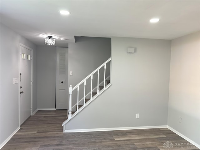 entryway with baseboards, recessed lighting, wood finished floors, and stairway