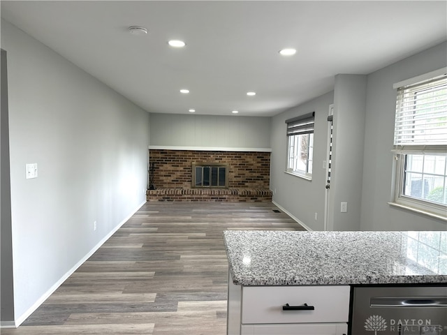 living area featuring plenty of natural light, recessed lighting, wood finished floors, and a fireplace