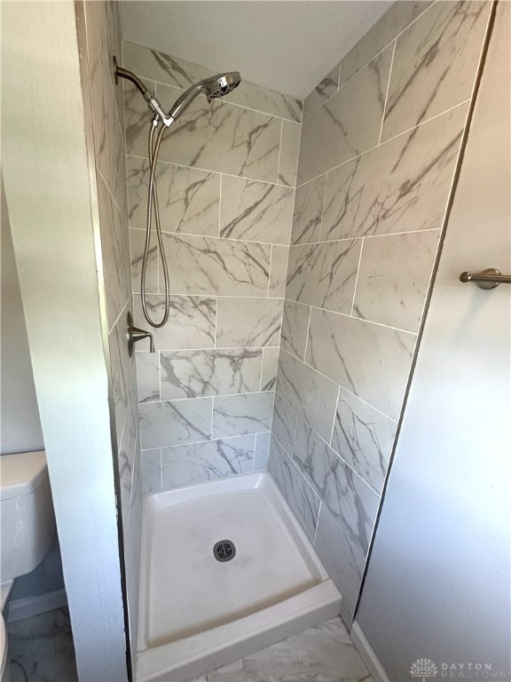 full bathroom with a shower stall and toilet
