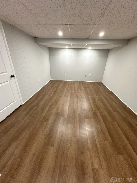 finished basement with dark wood finished floors and a paneled ceiling