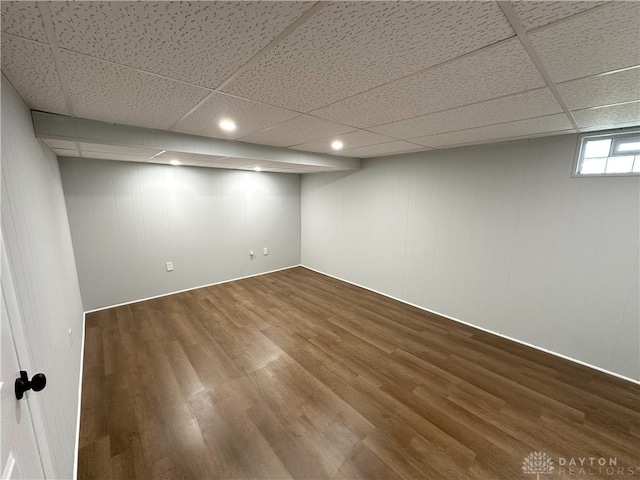 basement featuring a drop ceiling and wood finished floors