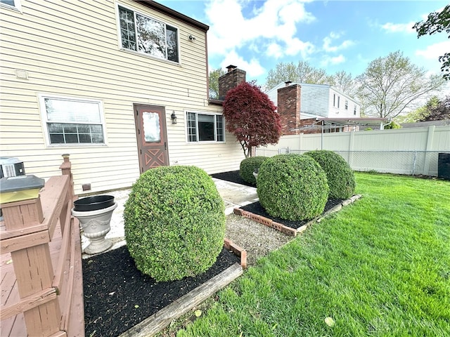 doorway to property featuring a yard and fence
