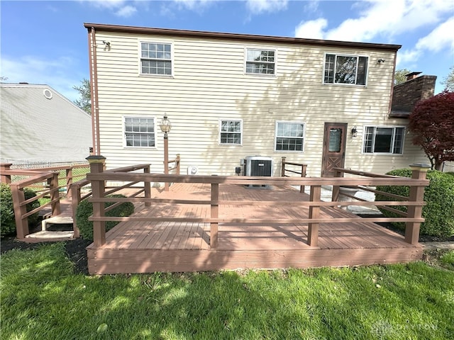 back of property with cooling unit and a wooden deck