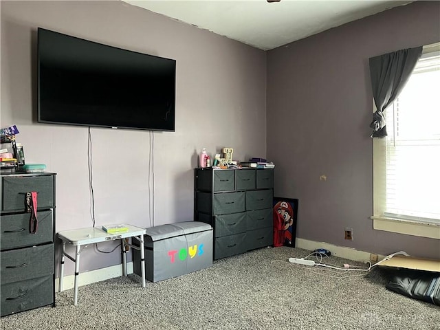 bedroom with multiple windows and carpet flooring