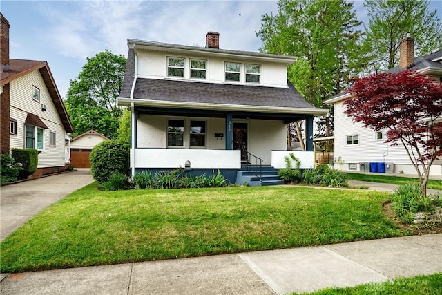 view of front facade featuring a detached garage, stucco siding, a porch, and a front yard