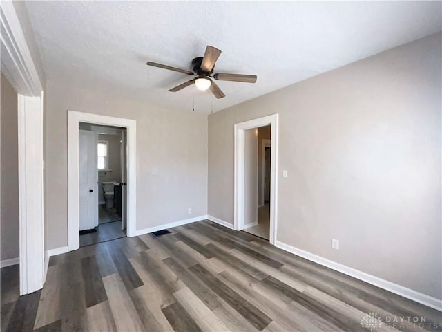 2828 Wilbraham Rd, Middletown, OH 45042 - unfurnished bedroom featuring baseboards, ceiling fan, ensuite bath, and dark wood-style floors
