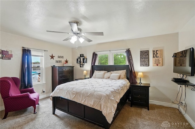 carpeted bedroom featuring a ceiling fan and baseboards