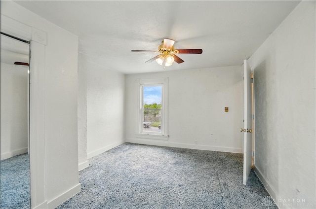 unfurnished bedroom with baseboards, carpet flooring, and a ceiling fan