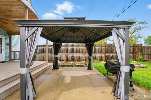 view of patio featuring a deck, a gazebo, a fenced backyard, and a grill
