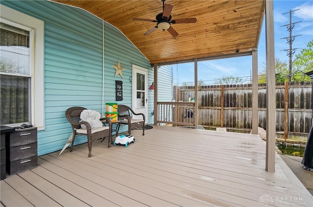 wooden deck featuring ceiling fan and fence