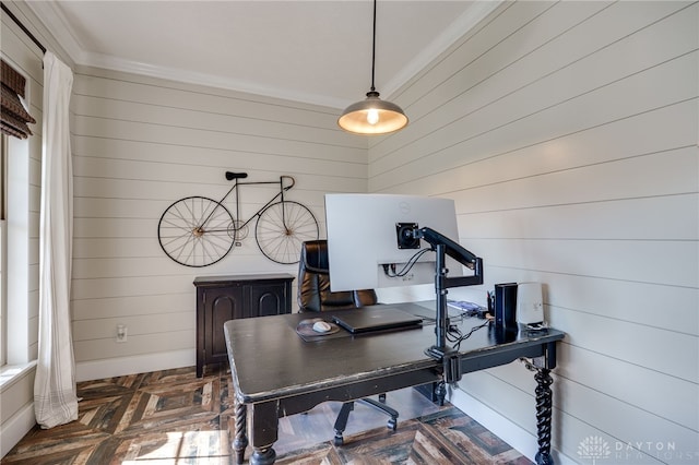 home office featuring crown molding, baseboards, and wood walls