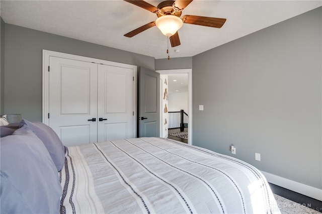 bedroom with a closet, a ceiling fan, and baseboards