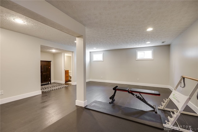 workout area with recessed lighting, baseboards, a textured ceiling, and wood finished floors