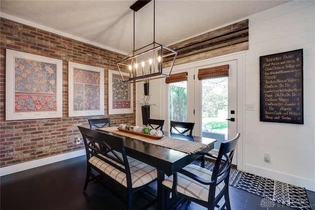 dining space featuring baseboards, an inviting chandelier, and dark wood finished floors