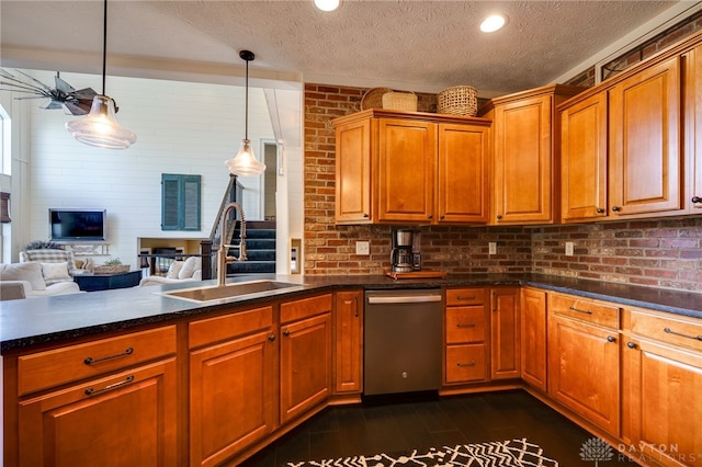 kitchen featuring dark wood-style flooring, a sink, dishwasher, a textured ceiling, and brick wall