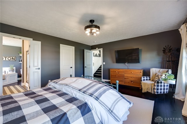 bedroom featuring baseboards and wood finished floors