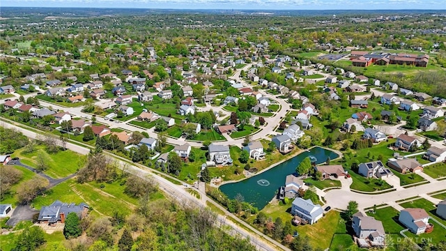 drone / aerial view with a water view and a residential view