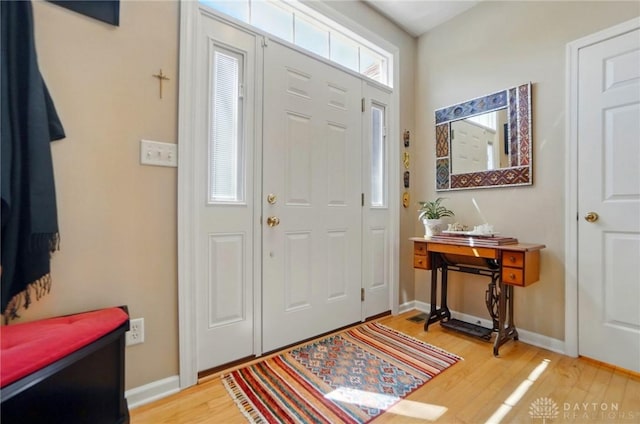 entryway with baseboards and light wood-style floors