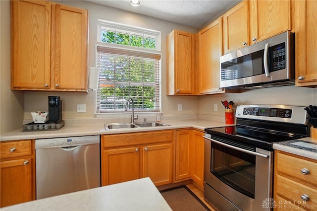 kitchen with light countertops, stainless steel appliances, and a sink