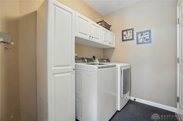 washroom with baseboards, cabinet space, and independent washer and dryer