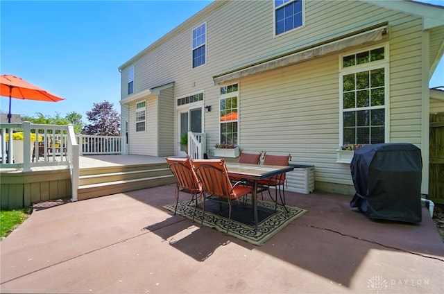 back of house featuring a patio, outdoor dining space, and a deck