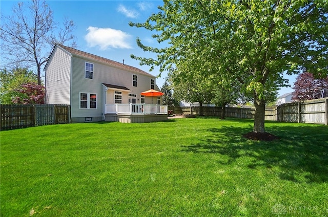 rear view of property with a lawn, a fenced backyard, and a wooden deck