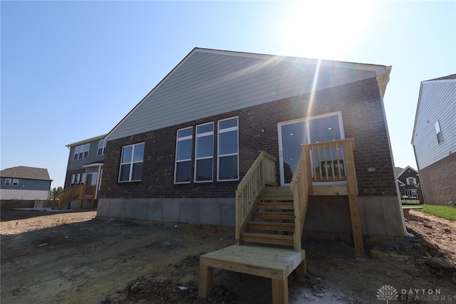 2885 Sky Crossing Dr Unit 56, Beavercreek, OH 45434 - rear view of house with brick siding, stairs, and a wooden deck