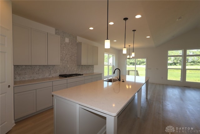 2885 Sky Crossing Dr Unit 56, Beavercreek, OH 45434 - kitchen with light wood-style floors, tasteful backsplash, recessed lighting, gas stovetop, and an island with sink