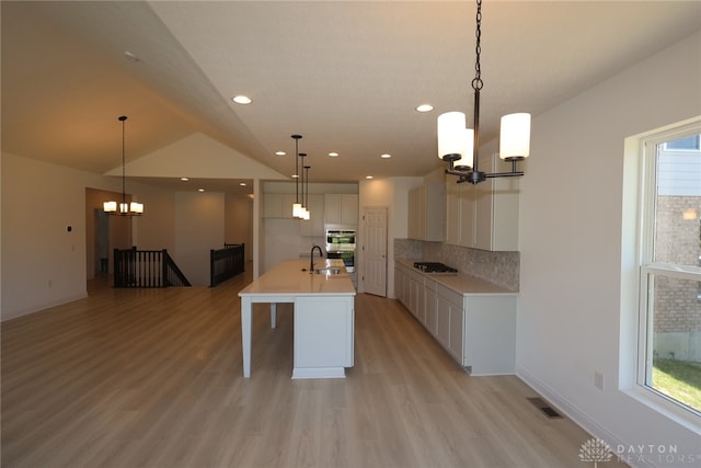 2885 Sky Crossing Dr Unit 56, Beavercreek, OH 45434 - kitchen featuring a chandelier, stovetop, light wood-style flooring, white cabinets, and recessed lighting