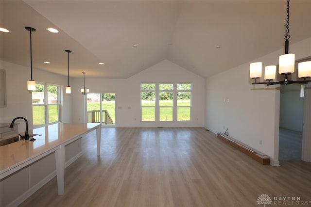 2885 Sky Crossing Dr Unit 56, Beavercreek, OH 45434 - kitchen with a chandelier, light wood finished floors, lofted ceiling, recessed lighting, and light countertops