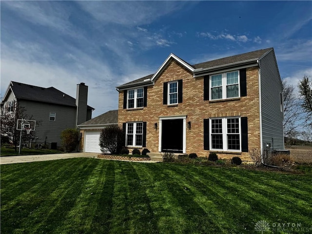 colonial-style house with brick siding, an attached garage, driveway, and a front yard