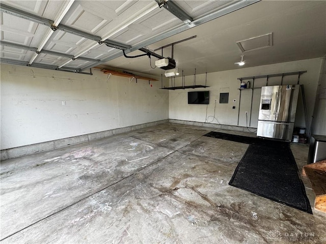 2240 Pacer Ct, Beavercreek Township, OH 45434 - garage with stainless steel fridge, a garage door opener, and electric panel