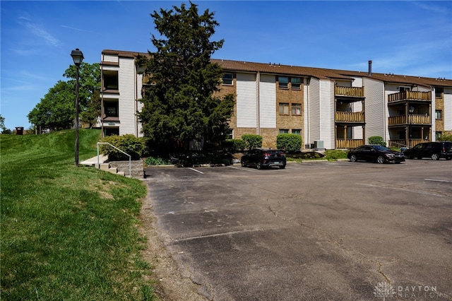 view of building exterior with uncovered parking
