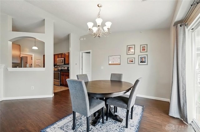 1304 Shadowood Trl, Maineville, OH 45039 - dining space with baseboards, arched walkways, a chandelier, lofted ceiling, and dark wood-style floors