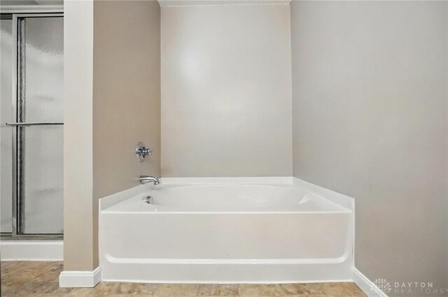 1304 Shadowood Trl, Maineville, OH 45039 - bathroom featuring a garden tub, a shower stall, and baseboards