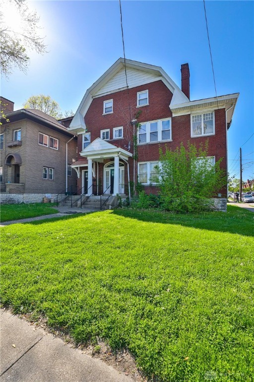 3733-3735 Reading Rd, Cincinnati, OH 45229 - back of property featuring a yard, brick siding, and a chimney