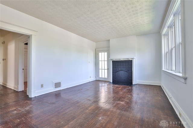 3733-3735 Reading Rd, Cincinnati, OH 45229 - unfurnished living room featuring visible vents, a fireplace with flush hearth, baseboards, and wood finished floors