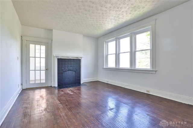 3733-3735 Reading Rd, Cincinnati, OH 45229 - unfurnished living room with a textured ceiling, baseboards, a fireplace with flush hearth, and dark wood-style floors