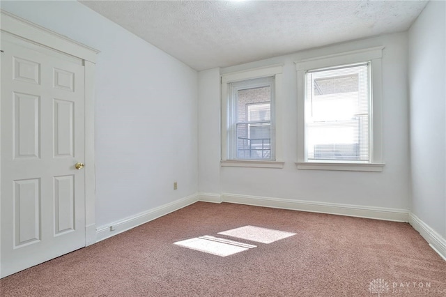 3733-3735 Reading Rd, Cincinnati, OH 45229 - empty room with baseboards, carpet, and a textured ceiling