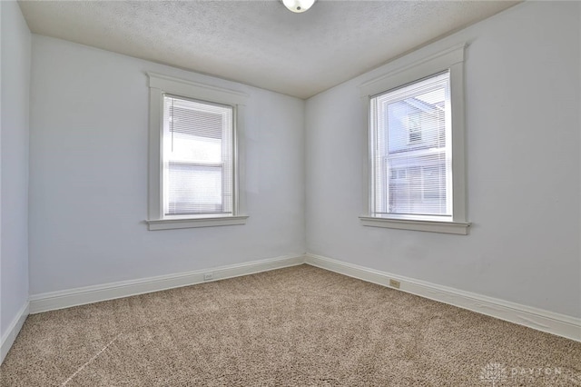 3733-3735 Reading Rd, Cincinnati, OH 45229 - carpeted spare room featuring baseboards, a textured ceiling, and a wealth of natural light