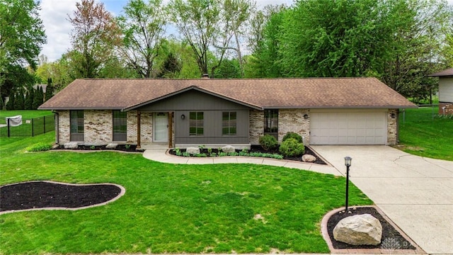 ranch-style house with fence, a front yard, brick siding, an attached garage, and driveway