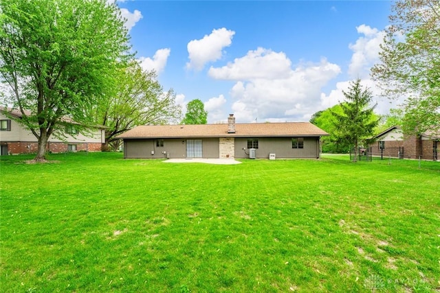 1330 E Centerville Station Rd, Dayton, OH 45459 - rear view of property featuring a lawn, fence, a patio, and a chimney