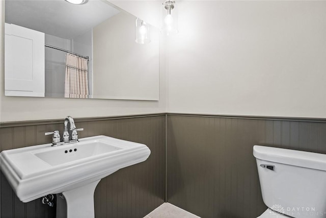 1330 E Centerville Station Rd, Dayton, OH 45459 - bathroom with a sink, a wainscoted wall, and toilet
