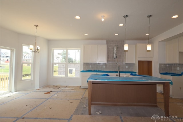 2014 Glen Valley Dr Unit 218, Washington Twp, OH 45458 - kitchen with backsplash, white cabinetry, an island with sink, and recessed lighting