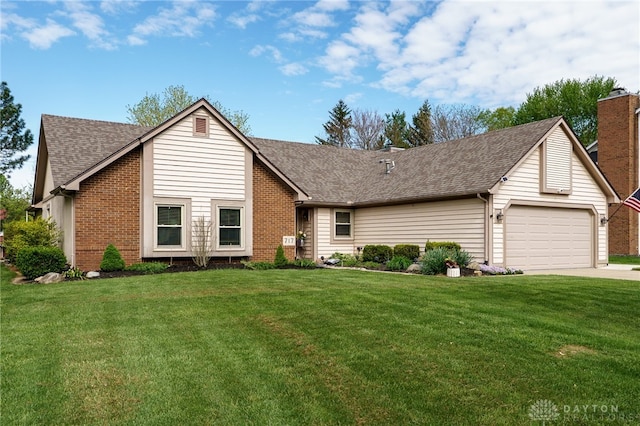 717 Walden Way, Dayton, OH 45440 - view of front of home with roof with shingles, a garage, a front lawn, and brick siding