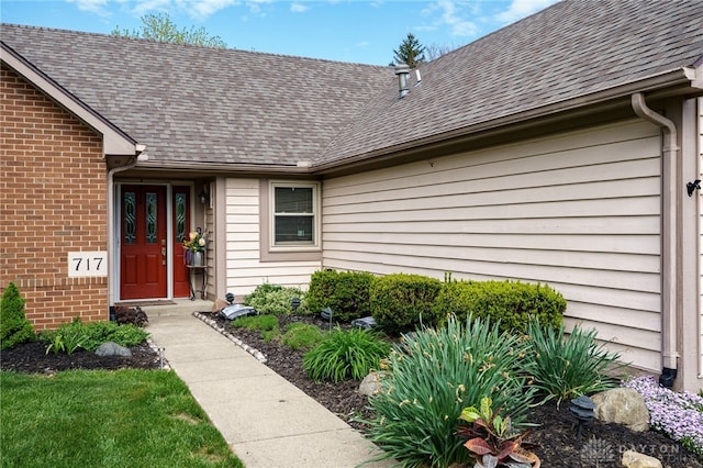 717 Walden Way, Dayton, OH 45440 - property entrance with a shingled roof and brick siding