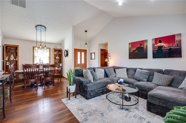 717 Walden Way, Dayton, OH 45440 - living room with a notable chandelier, dark wood finished floors, visible vents, and vaulted ceiling