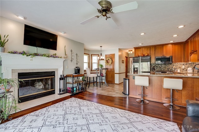 717 Walden Way, Dayton, OH 45440 - living area with a premium fireplace, wood finished floors, a ceiling fan, and recessed lighting