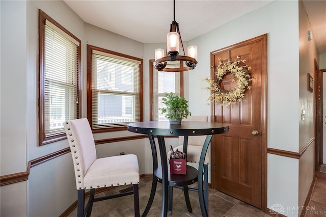 717 Walden Way, Dayton, OH 45440 - dining space featuring baseboards and a notable chandelier