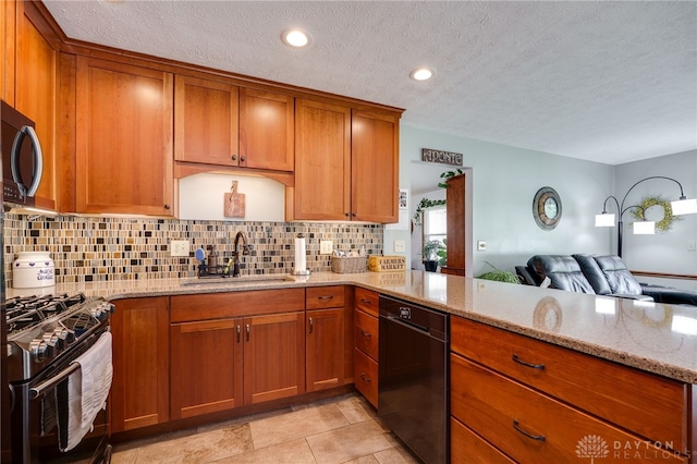 717 Walden Way, Dayton, OH 45440 - kitchen with brown cabinetry, black appliances, decorative backsplash, and a sink